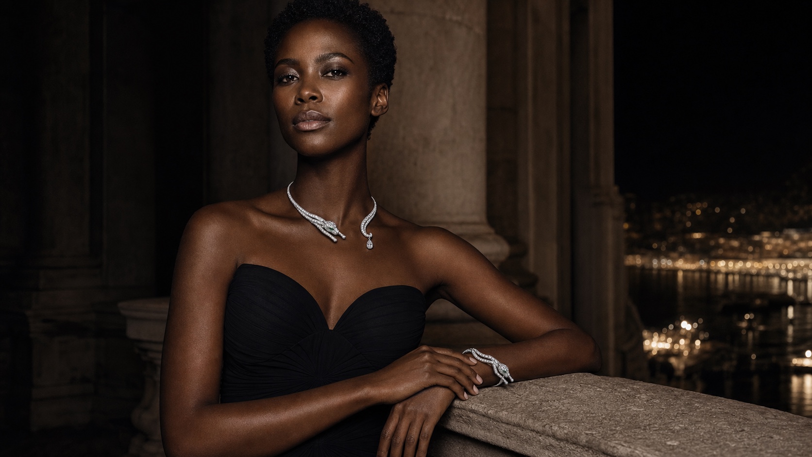 A Black woman in a black strapless gown wearing the FELIS panther collar and bracelet in white gold with natural emerald eyes.